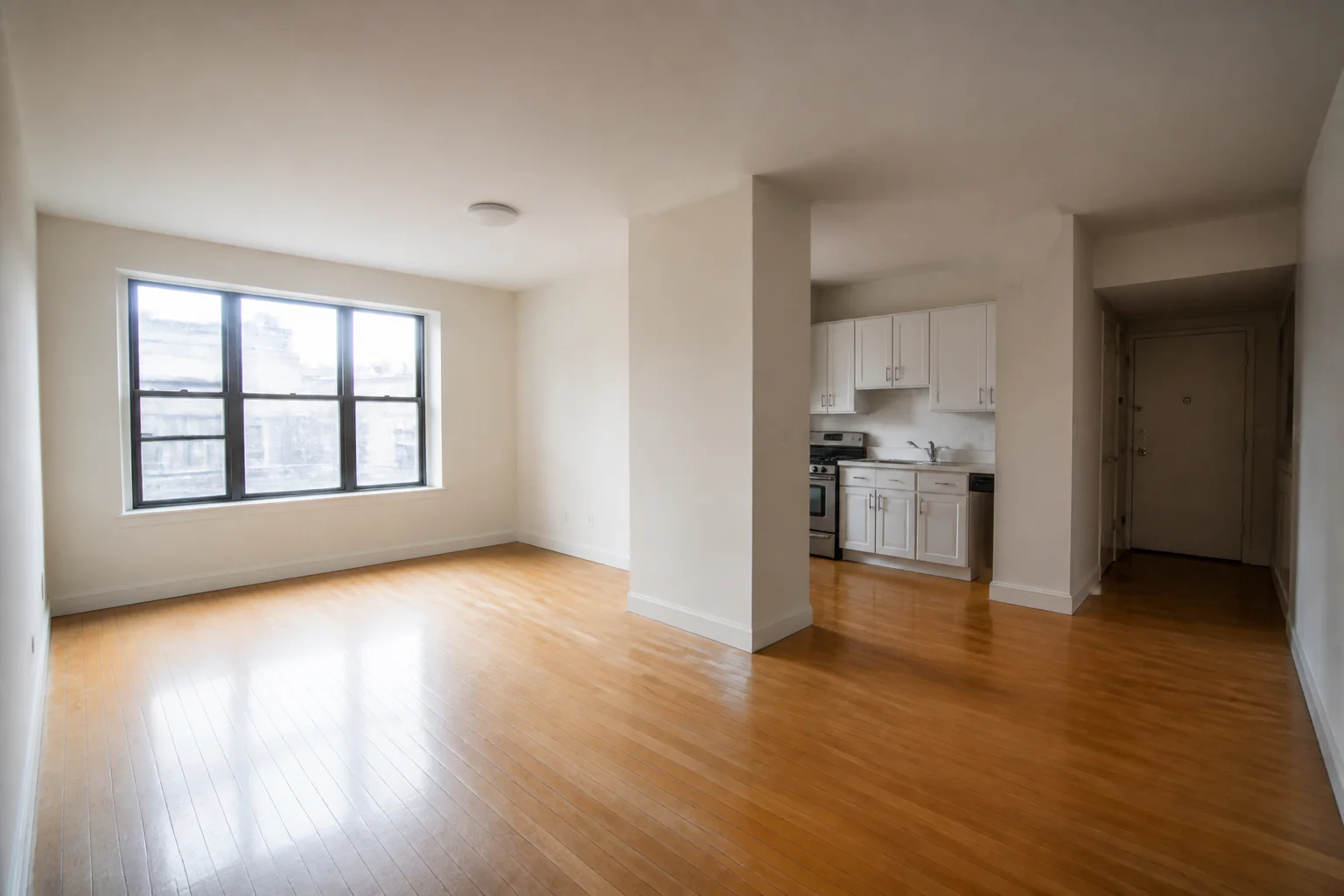 AI-generated demonstration of a vacant compact rental studio with a small kitchen